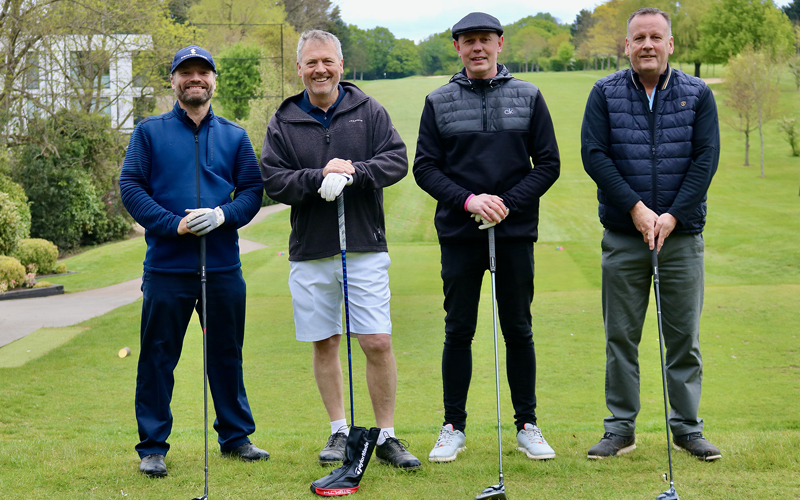 4 Men With Golf Clubs at Golfcourse For Charity Competition