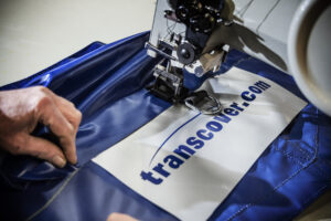 Tarpaulin manufacturing using blue mesh sewing Transcover tag