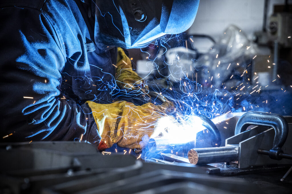 Man welding in a manufacturing factory 